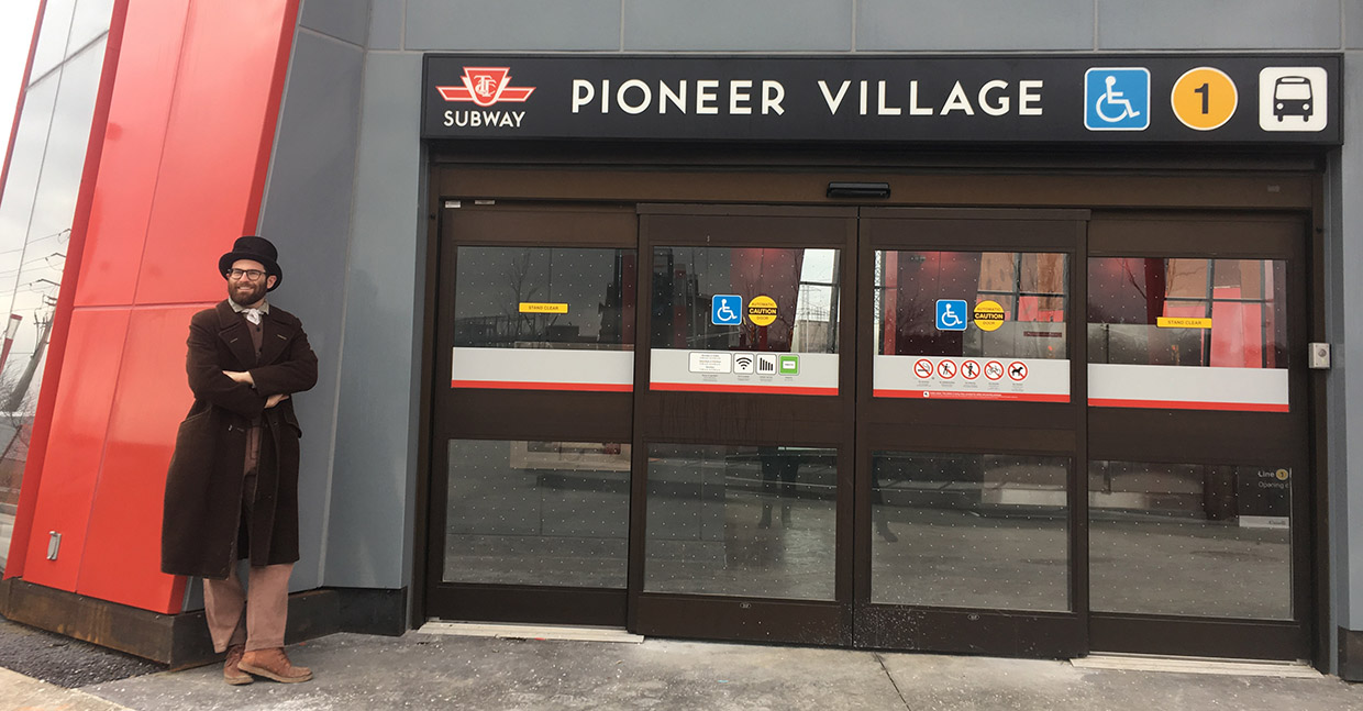 history actor in period costume at entrance to pioneer village subway station