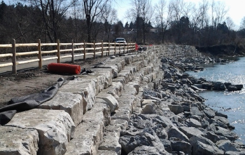 paddle fence along the armourstone retaining wall