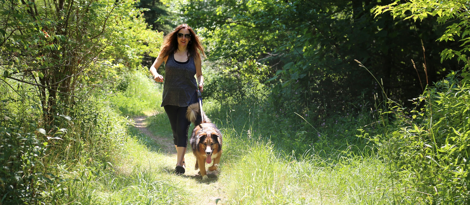 woman walking dog on leash at TRCA park