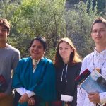 Indigenous teens pose with Elder Whabagoon at eagle feather ceremony