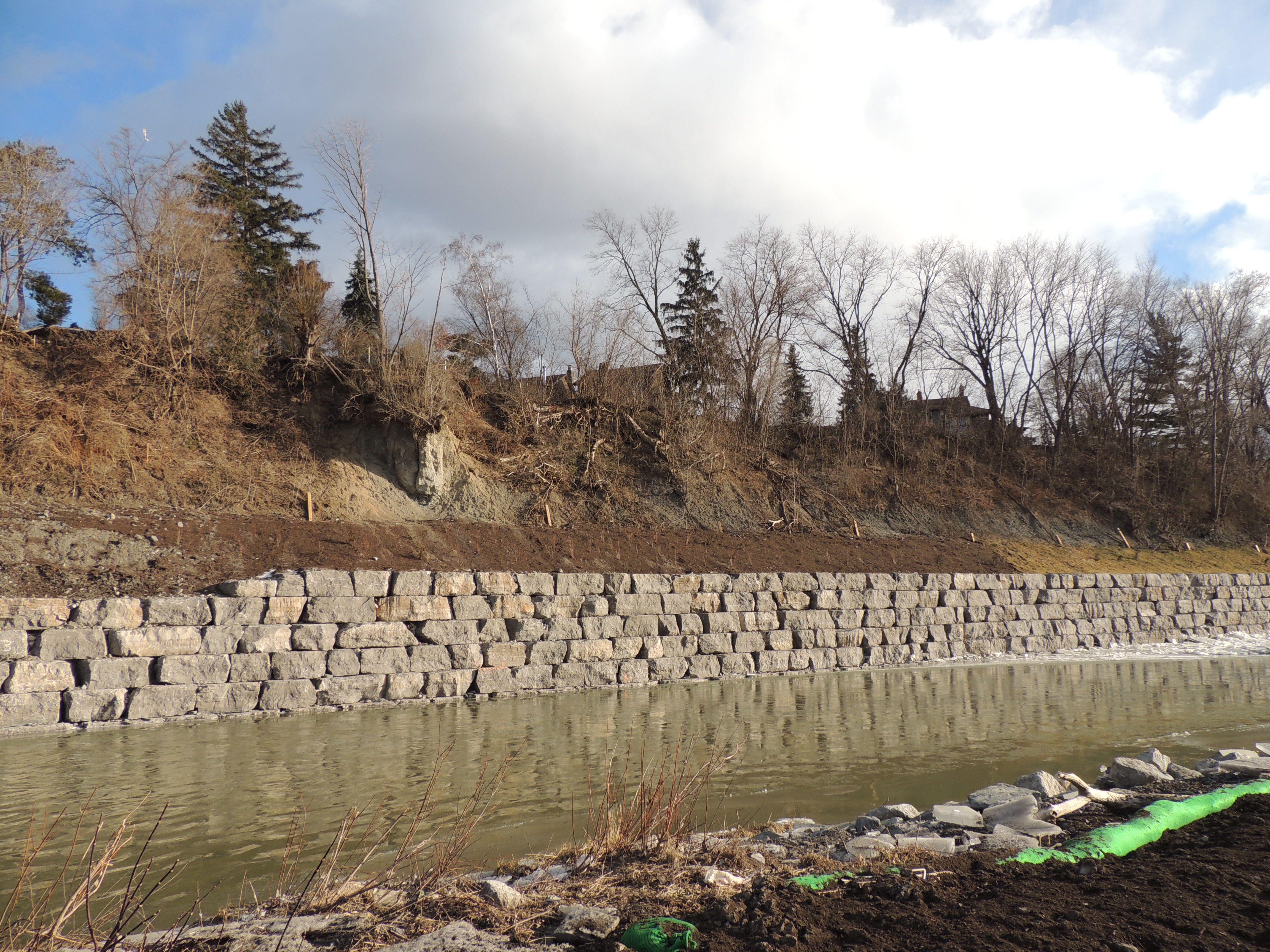 An armourstone wall and soil stabilization measures at the toe of a steep slope overlooking the Humber River