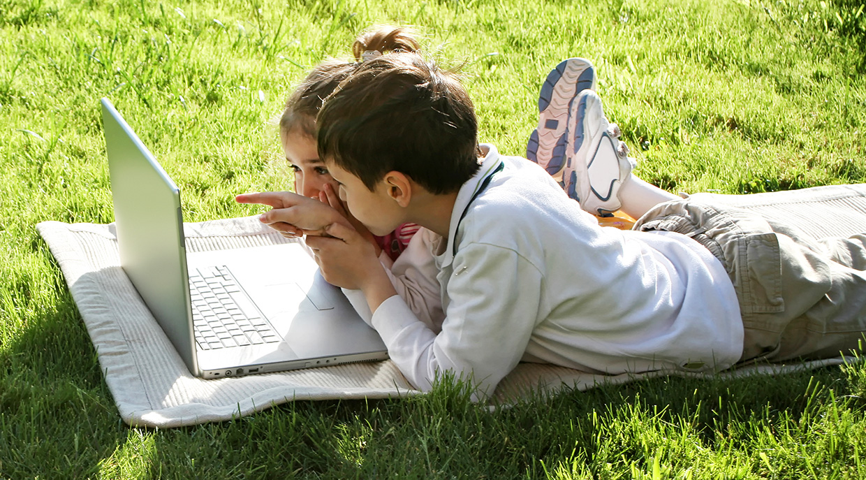 children outdoors with laptop participate in fun virtual summer camp activities from TRCA
