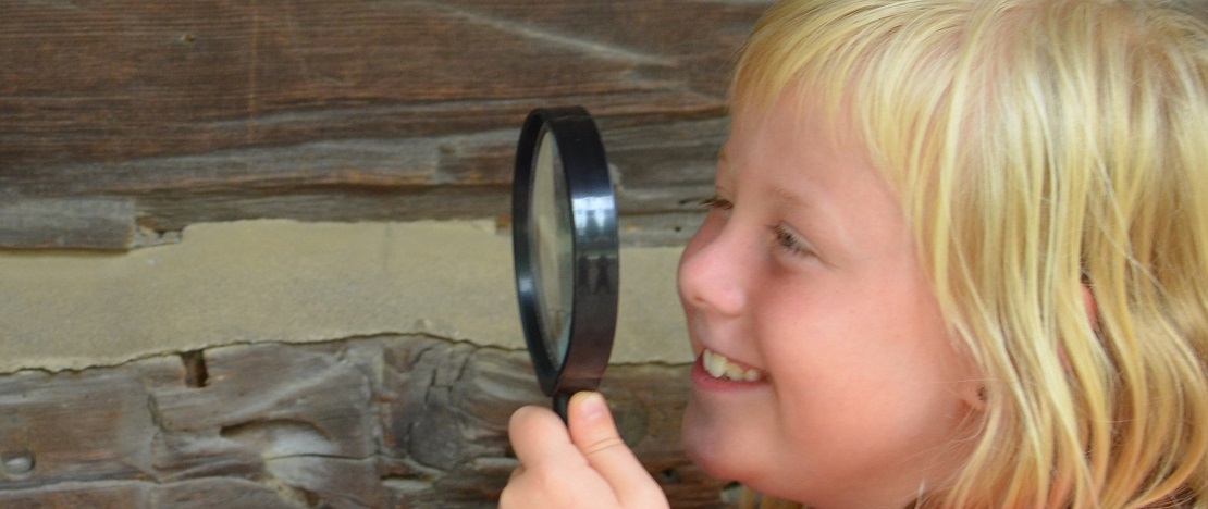 girl with magnifying glass participates in TRCA virtual nature spy camp