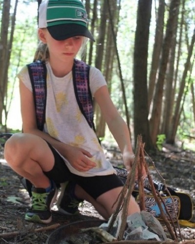 summer camper learns to build a campfire at Claremont Nature Centre