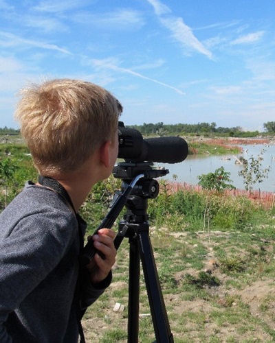 summer camper enjoys an introduction to bird watching at Tommy Thompson Park