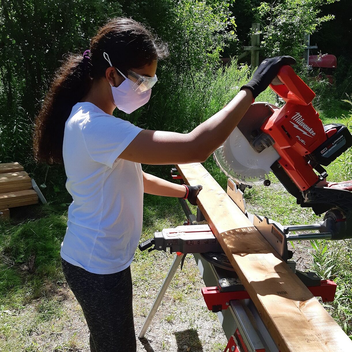 Participant in TRCA Girls Can Too program learns to use circular saw