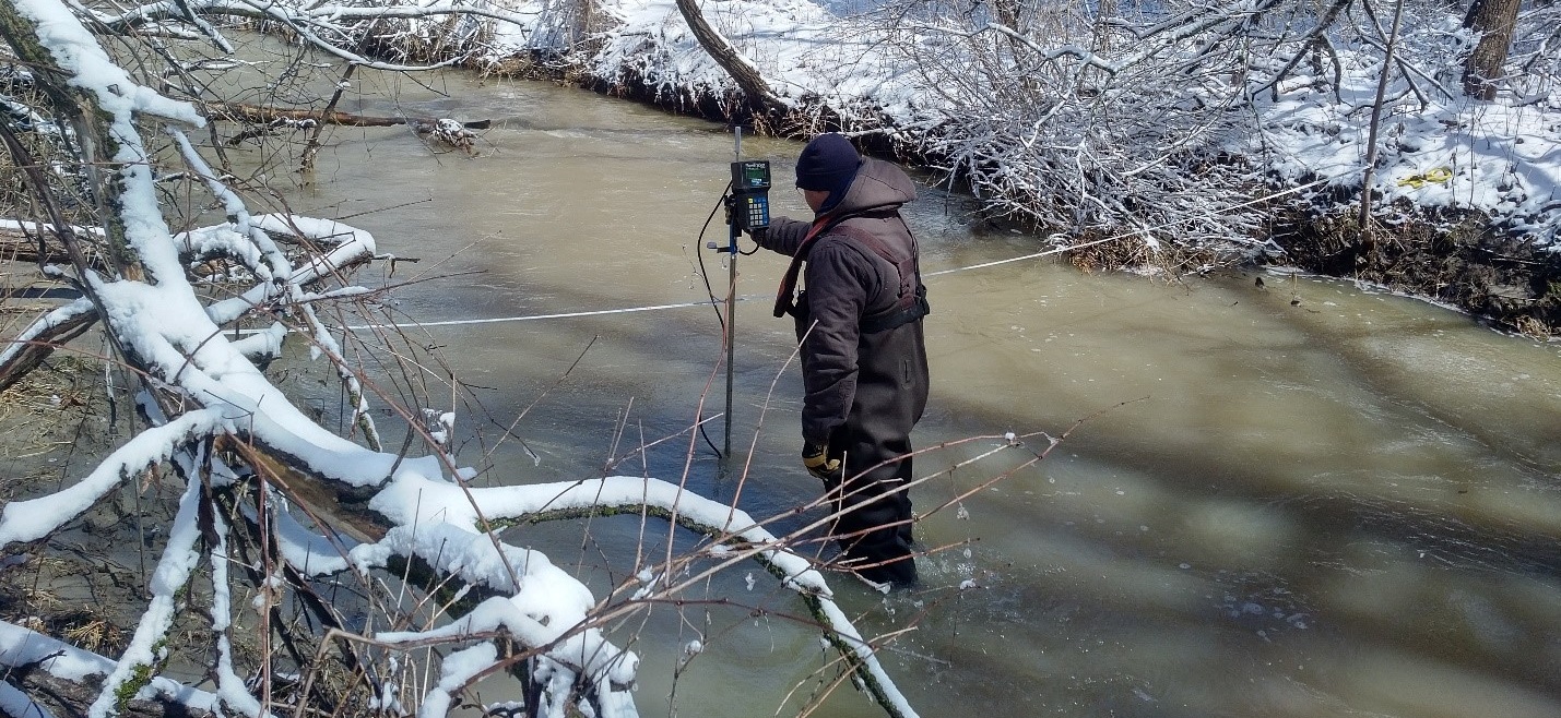 TRCA team member takes stream flow measurements using a FlowTracker