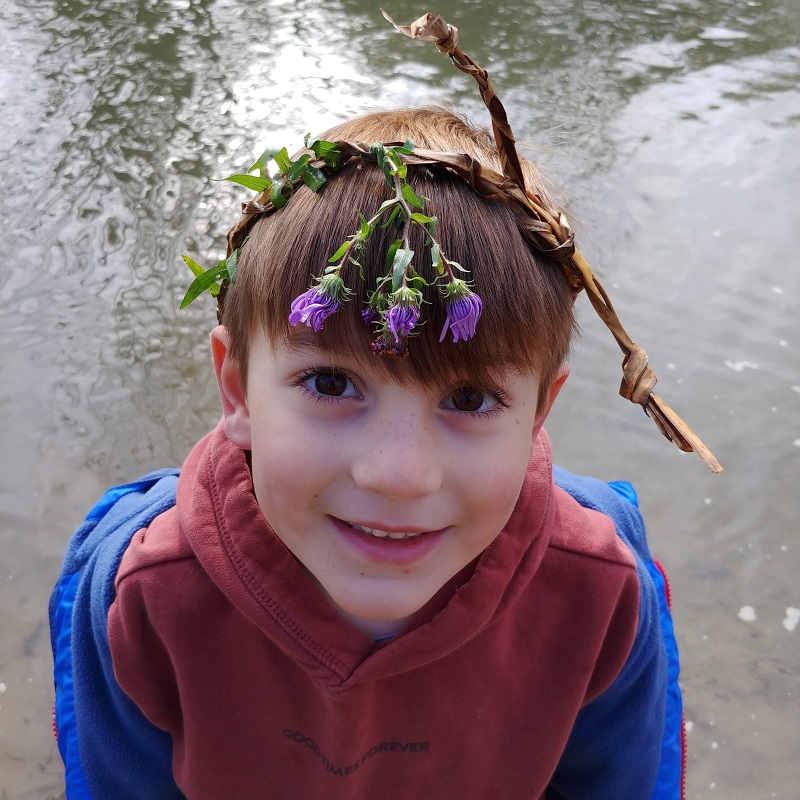camper explores a stream on an outdoor summer camp adventure at Claireville Conservation Area