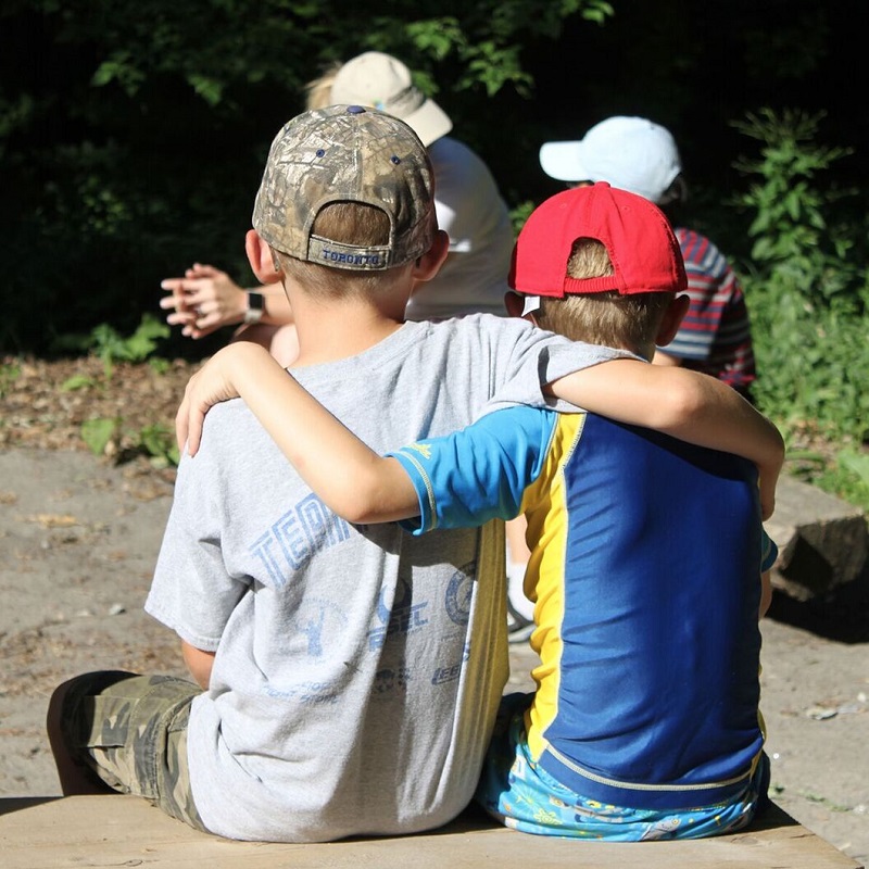 summer campers sit by campfire at Claremont Nature Centre