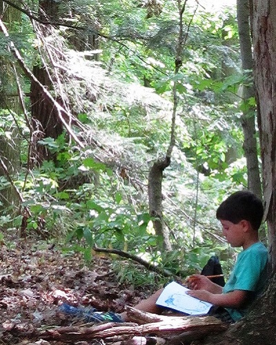 summer camper discovers the magic of the forest at Kortright Centre