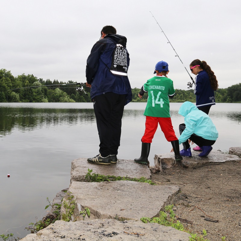 members of young family go fishing at Heart Lake Conservation Park