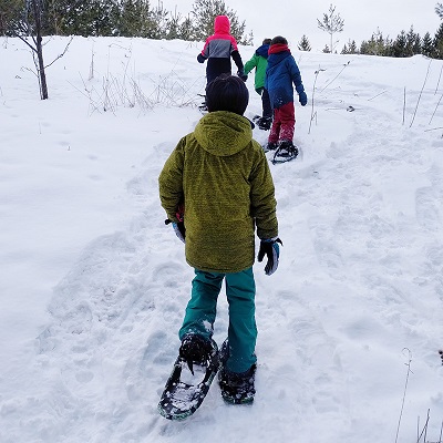 children go on a snowshoeing adventure during birthday party at Claireville Conservation Area