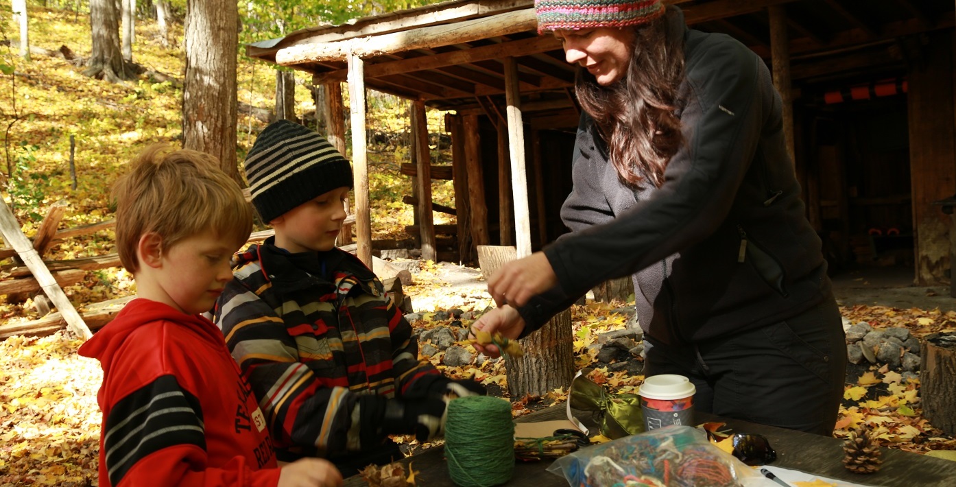 Nature School students make forest crafts with instructor