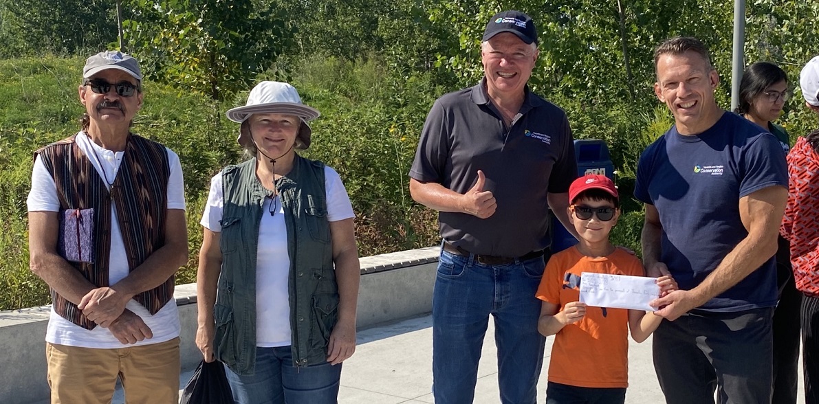 TRCA chair Paul Ainslie and CEO John MacKenzie greet young butterfly enthusiast Evan Huynh and Indigenous dignitaries at TRCA Butterfly Festival at Tommy Thompson Park