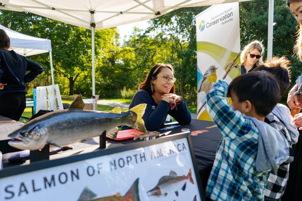 young visitors to the TRCA Adventures of Salmon event explore an interactive educational booth