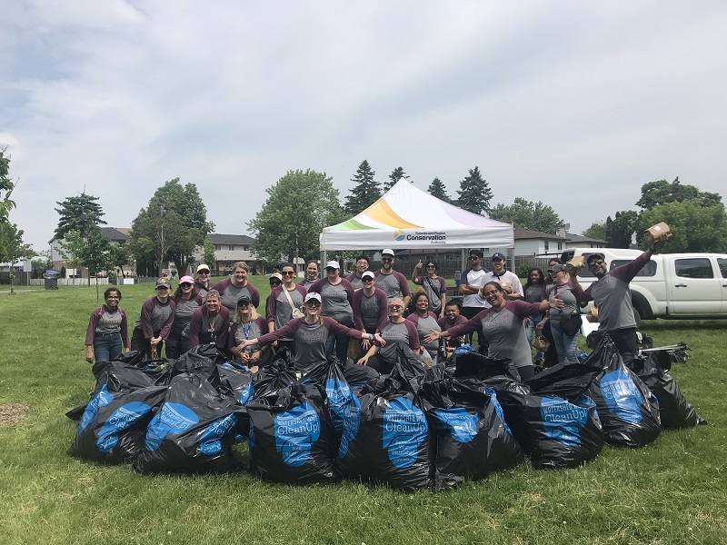 volunteers celebrate the successful completion of a community litter cleanup event
