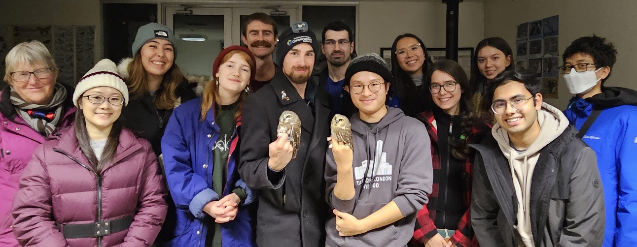 TRCA staff nd volunteers pose for a photo at the entrance of the Tommy Thompson Park Bird Research Station