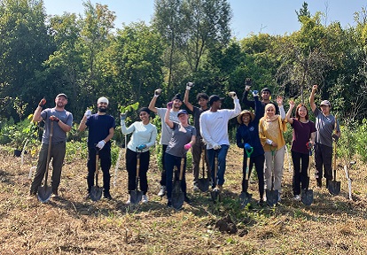 volunteers take part in a community stewardship tree planting event