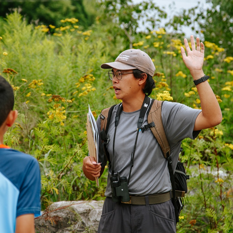 a TRCA team member leads a guided walk at the TRCA Butterfly Festival at Tommy Thompson Park