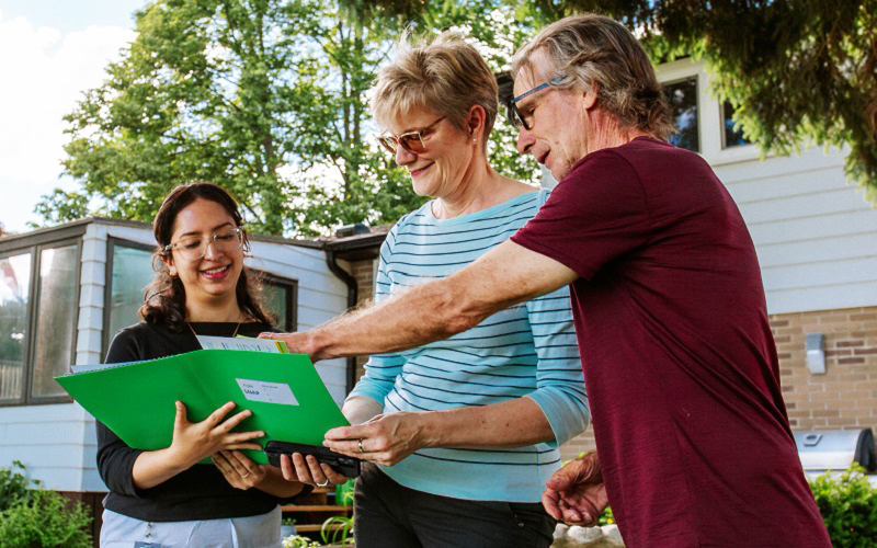 a SNAP climate ready homes program team member conducts a home visit with neighbourhood residents