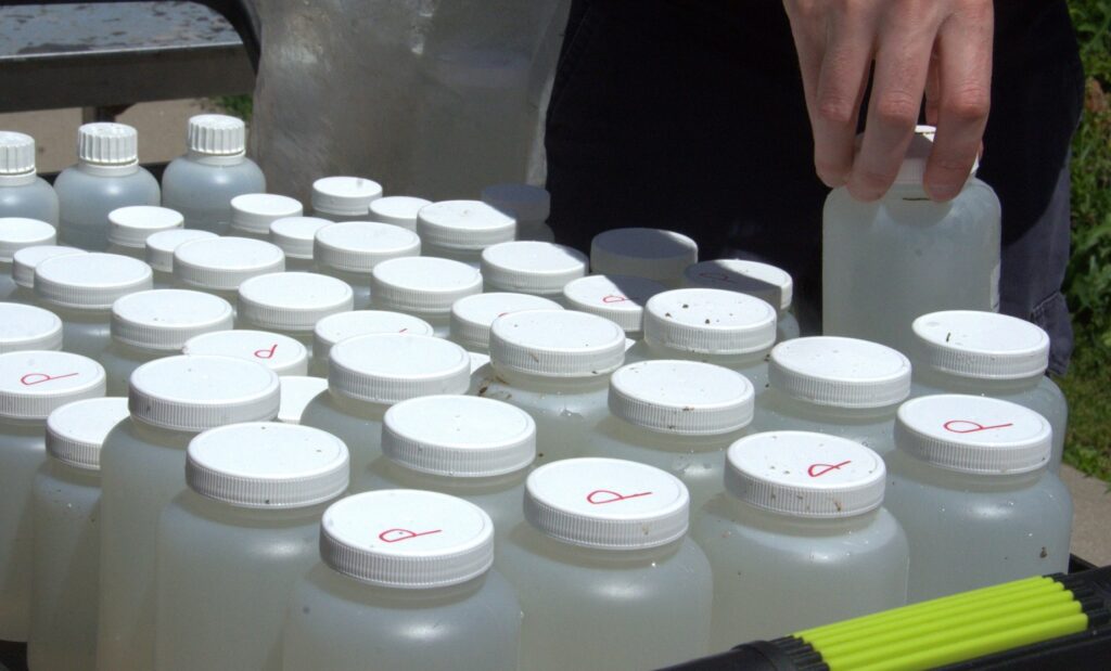 a TRCA team member collects water quality monitoring samples