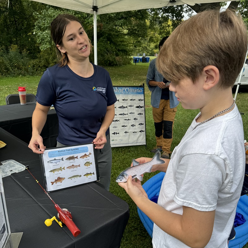 a young community member visits one of the many interactive stations at the TRCA Adventures of Salmon event at Morningside Park