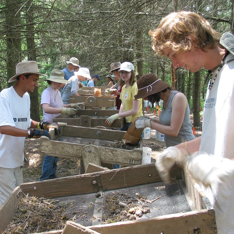 archival photograph of students taking part in a Boyd Archaeological Field School excavation
