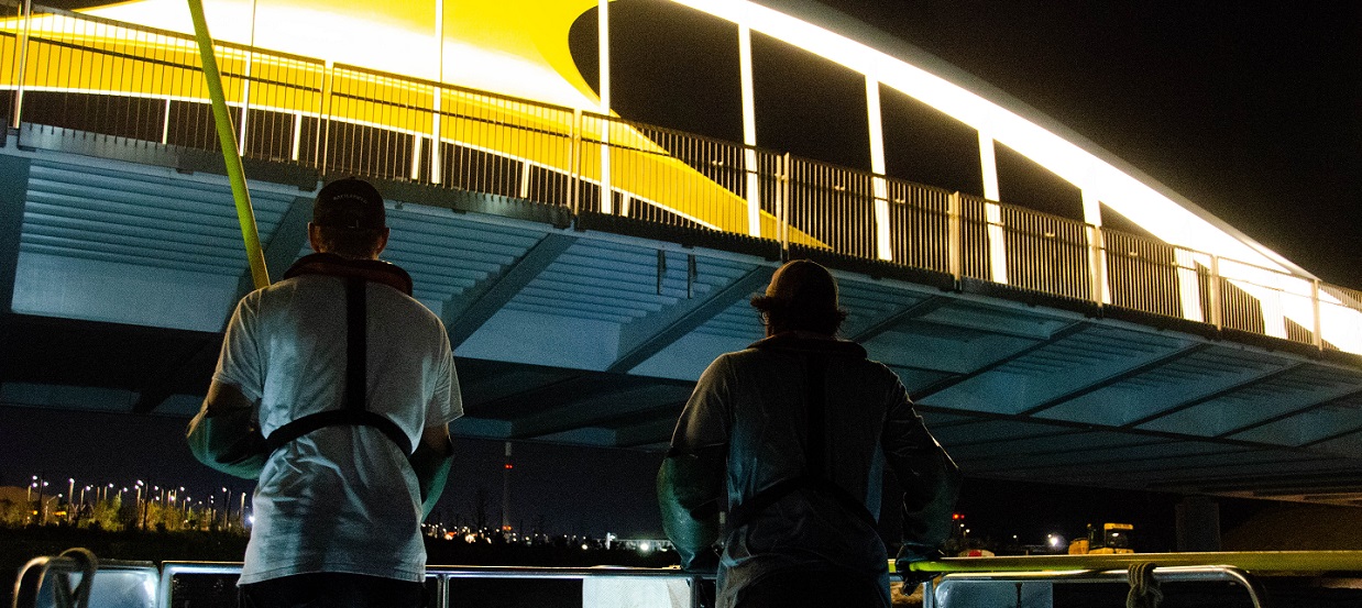 TRCA waterfront team members conduct an electrofishing survey at night under a bridge at the revitalized Don River Mouth