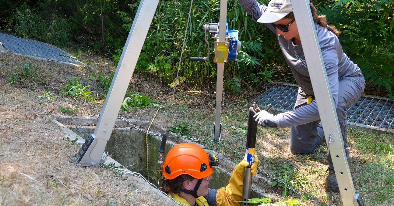members of the TRCA Real-Time Monitoring team perform maintenance on equipment used for stormwater monitoring
