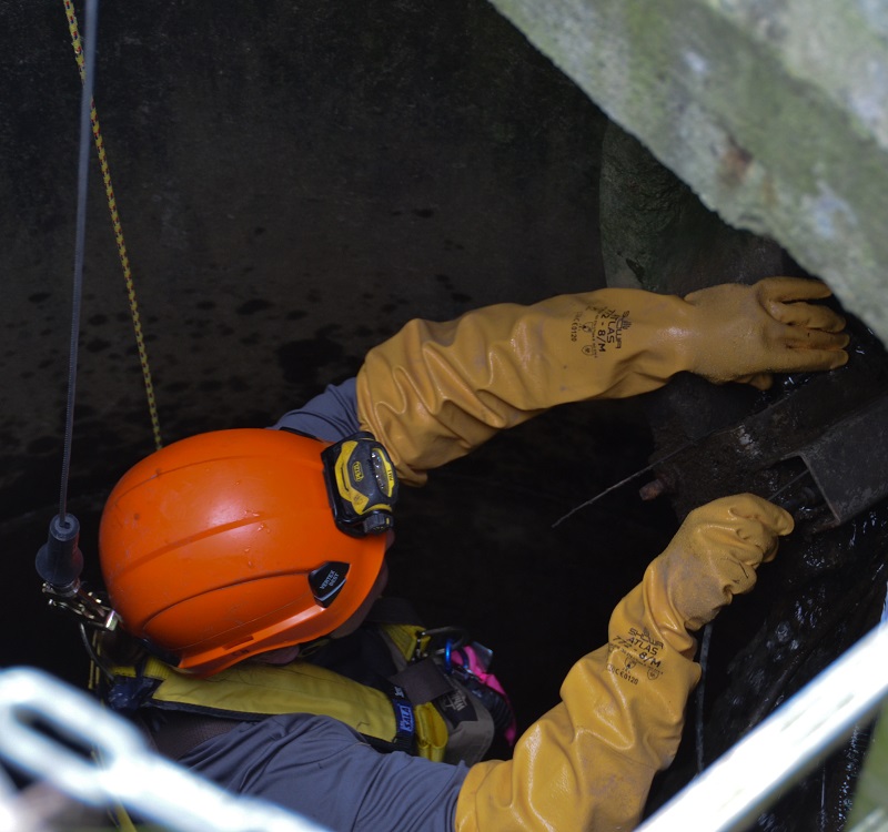 a member of the TRCA Real-Time Monitoring team performsmaintenance on equipment used for stormwater monitoring
