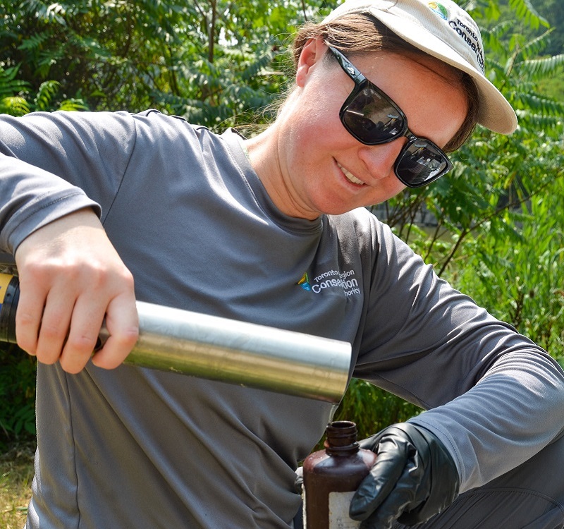 a member of the TRCA Real-Time Monitoring team performs maintenance on equipment used for stormwater monitoring
