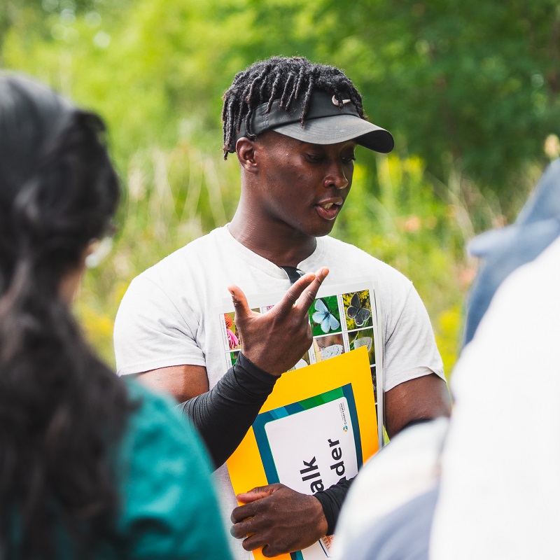 a TRCA volunteer leads a guided walk at the Butterfly Festival at Tommy Thompson Park