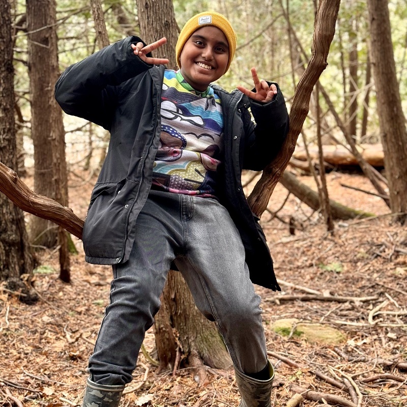 a student explores the forest during an overnight field trip to a TRCA outdoor education centre