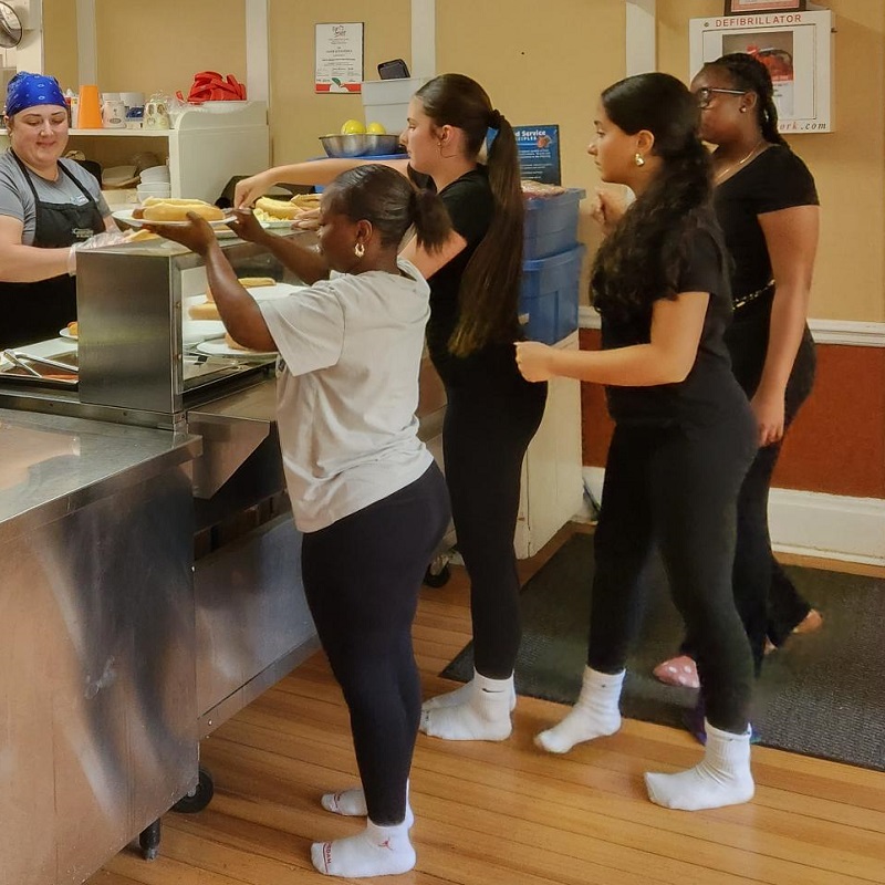 students on an overnight field trip enjoy a hot meal in the dining area at Lake St George Field Centre