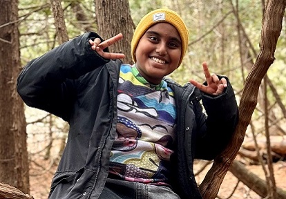 a student explores the forest during an overnight field trip to a TRCA outdoor education centre