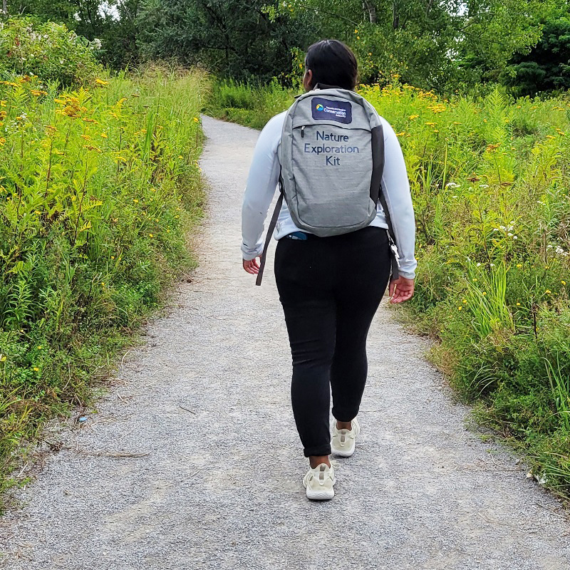 a visitor to Tommy Thompson Park carries a nature exploration kit backpack