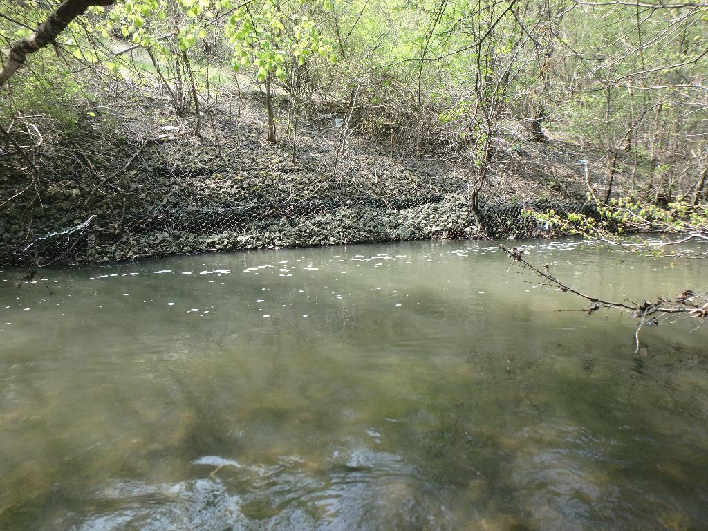 Photo of degraded erosion control structure (gabion baskets)