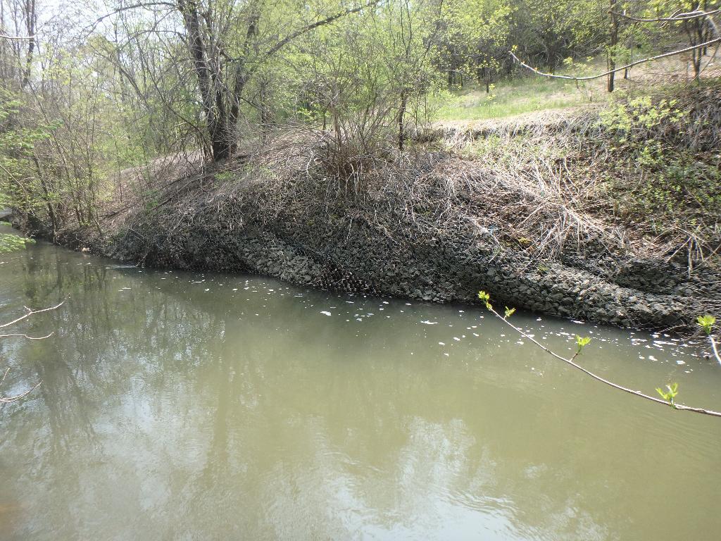 Photo of degraded erosion control structure (gabion baskets)