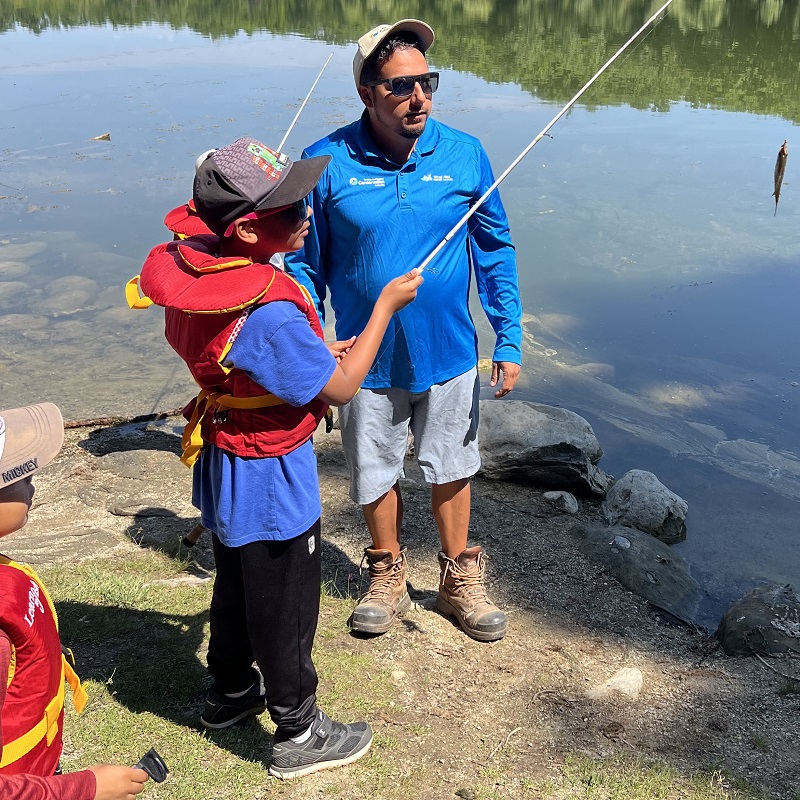 an experienced angler teaches youngsters to fish at Heart Lake Conservation Park