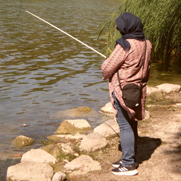 a young woman takes part in the Learn to Fish program at Heart Lake Conservation Park