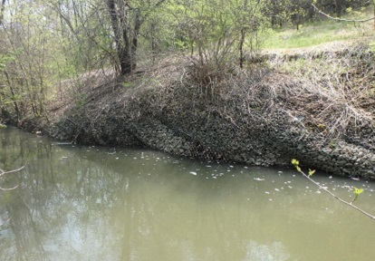 a view of the Canyon Avenue project area shows slumping of the slope behind the failing retaining wall
