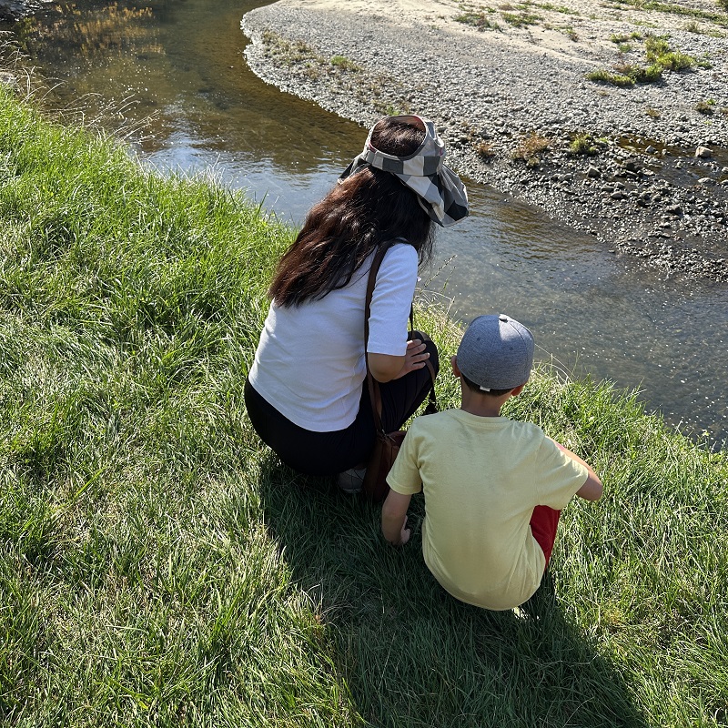 a mother and son overlook Highland Creek as they take part in the TRCA Adventures of Salmon event