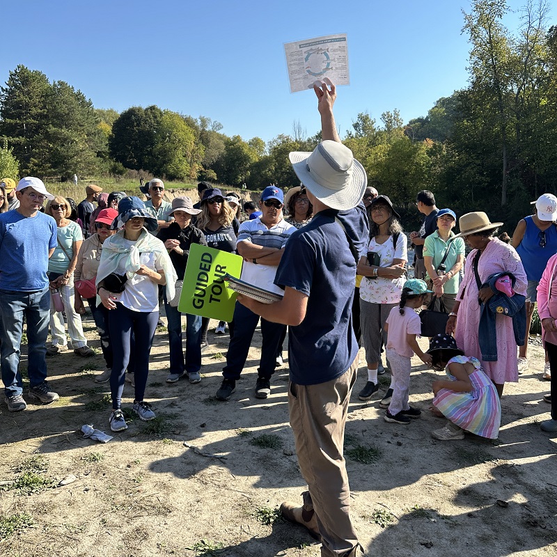 a TRCA team member leads a guided walk at the TRCA Adventures of Salmon event at Morningside Park