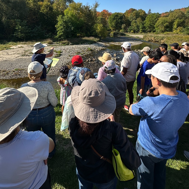 a TRCA team member leads a guided walk along the banks of Highland Creek at the TRCA Adventures of Salmon event at Morningside Park