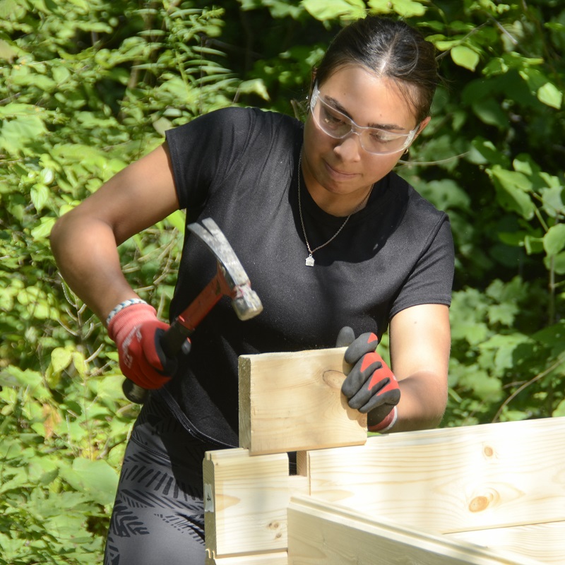a Girls Can Too program participant works on a construction project