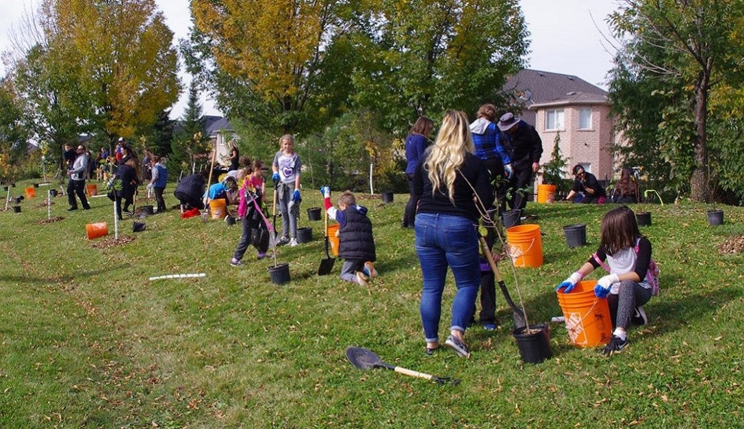 community members participate in a West Bolton SNAP neighbourhood tree planting event