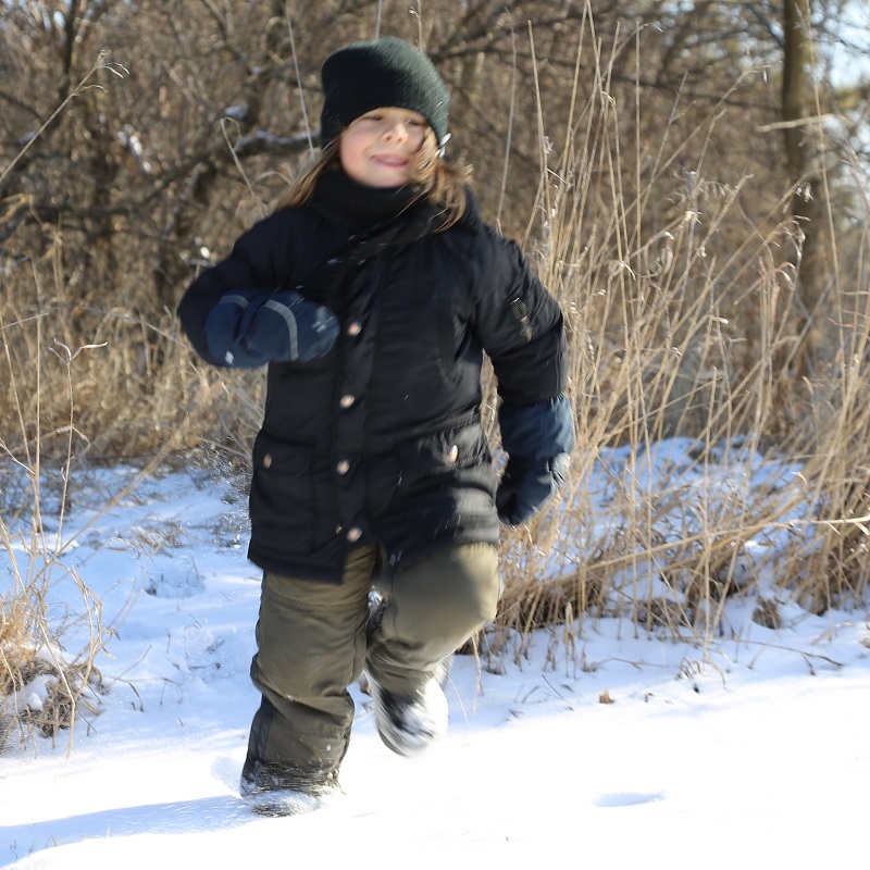 a student enjoys outdoor adventure in the snow at a TRCA winter camp at Claireville Outdoor Education Centre