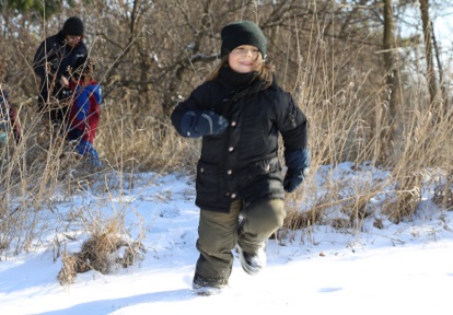 a student enjoys outdoor adventure in the snow at a TRCA winter camp at Claireville Outdoor Education Centre