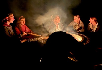 students gather around a fire pit at a TRCA overnight camp