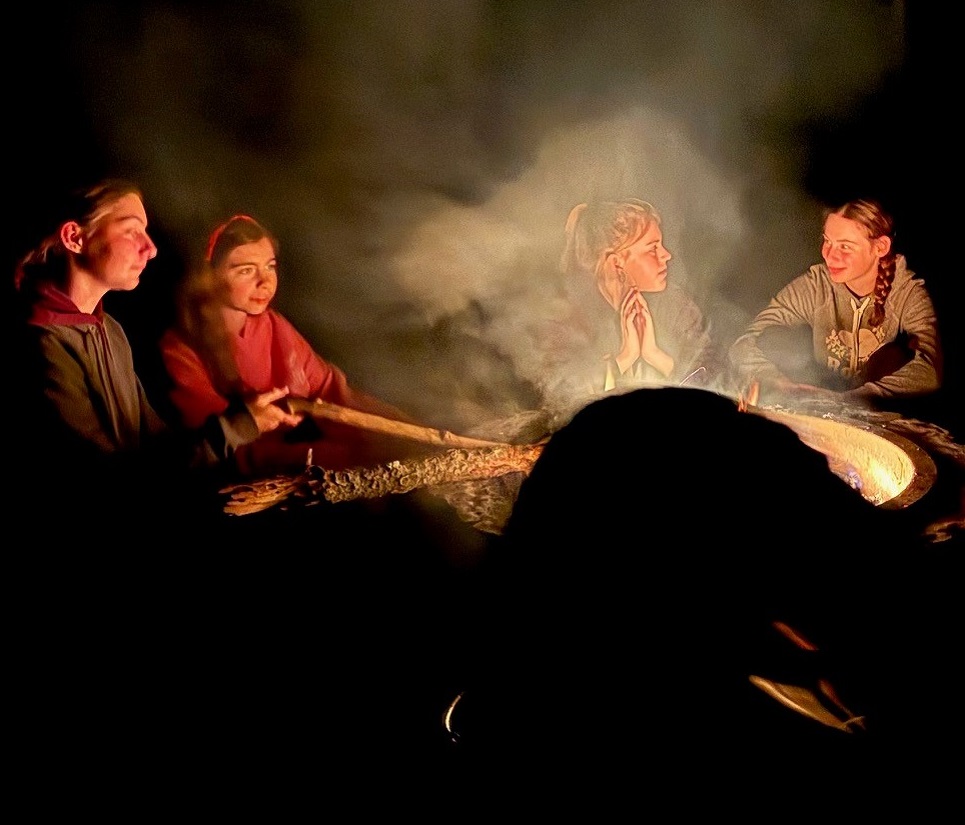 students gather around a fire pit at a TRCA overnight camp